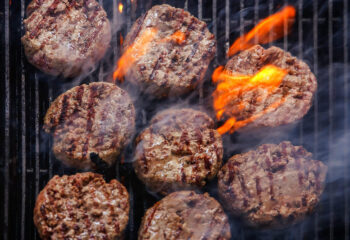 burger being cooked on a barbecue grill