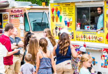 group of people in front of a snowball vtruck