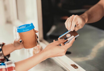 customer paying for coffee to a coffee truck owner